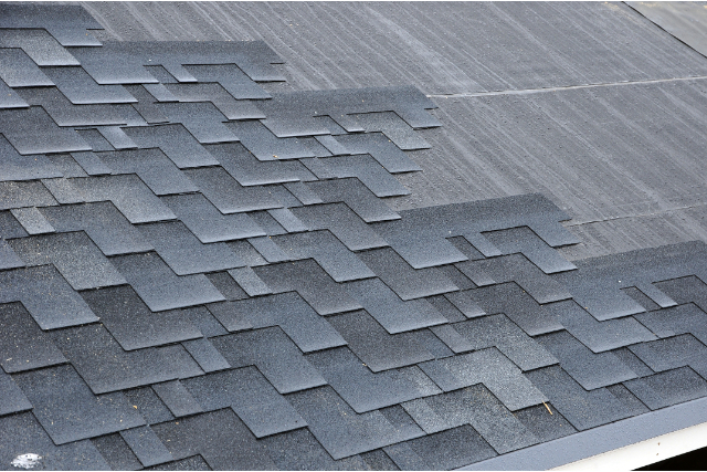 Installing asphalt roofing shingles on Columbus home